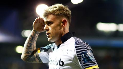 Derby County's Sammy Szmodics salutes the fans head shot in evening game victory at Fratton Park, wearing home white and black kit
