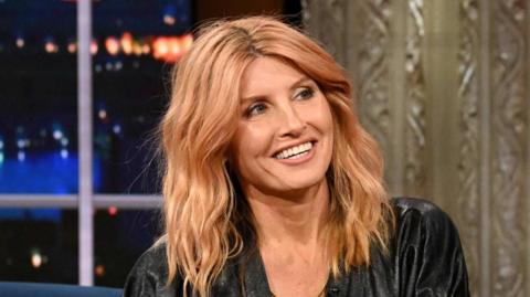 Sharon Horgan on The Late Show in November 2024. She has long strawberry blonde hair and is wearing a black dress.