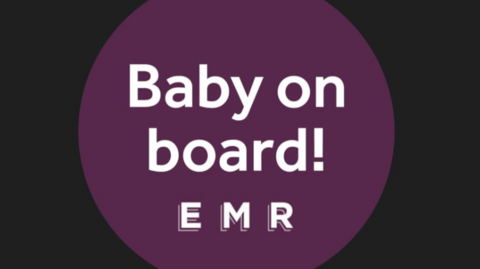 A purple, circular badge with the words Baby on Board EMR.