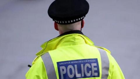 Back of a hi-vis jacket reading 'Greater Manchester Police'.