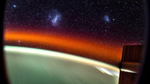 Picture taken from the window of the International Space Stations (ISS) which shows a large number of stars as well as the large Magellanic Cloud and Small Magellanic Cloud.