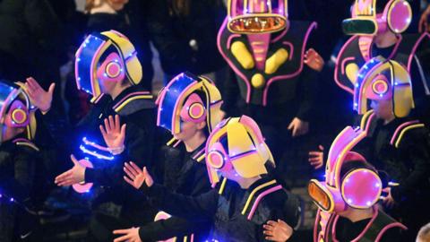 A line of children dressed as spacemen