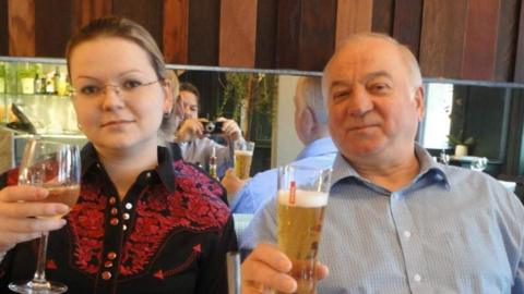 Yulia and Sergei Skripal in a restaurant holding beers