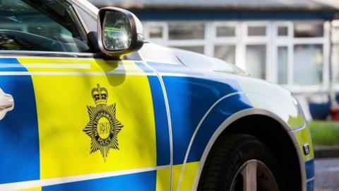 A Nottinghamshire Police panda car with a force logo on the side