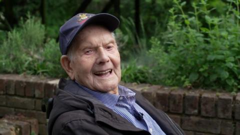 Mr Chafer wearing a blue baseball cap and smiling