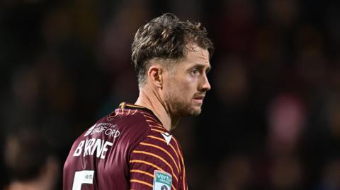 Neill Byrne, wearing number 5, playing for Bradford earlier this season