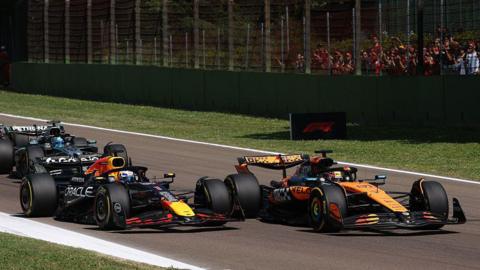 Red Bull's Max Verstappen moves alongside Oscar Piastri to pass him at the start of the Emilia-Romagna Grand Prix
