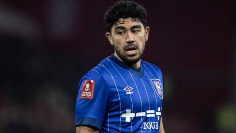 Massimo Luongo, wearing Ipswich's home blue jersey with white pin stripes