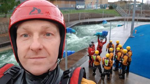 Retired firefighter Simon Carr in front of colleagues at a water rescue training day in 2021.