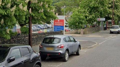 Two cars parked outside the A&E at Calderdale Royal Hospital. 