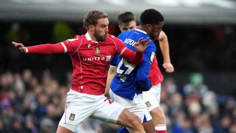 Wrexham's Sam Smith (left) and Ipswich Town's Chuba Akpom battle for the ball