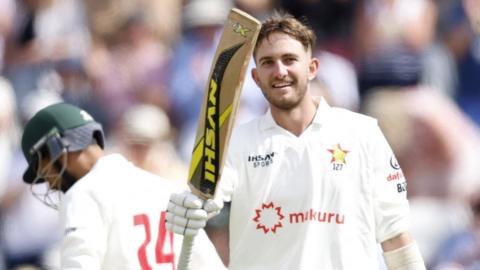Brian Bennett raises his bat