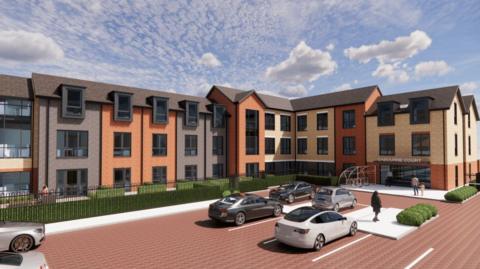 An artist's impression of the proposed care home. It shows a three-storey building with dark-coloured, red and yellow brick. Each floor has windows with black outlines. Green bushes and black metal fencing line the walkways outside the building. There is a large red brick car park with six black, white and silver cars parked in white-outlined spaces. People are walking towards the entrance of the building on the right of the photo. It has a bike rack outside. The sky is blue with light clouds.