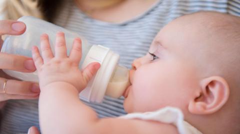 Baby drinking milk from a bottle