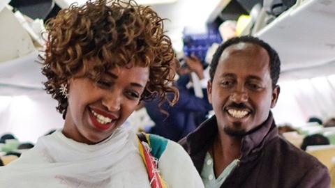 Passengers talk inside an Ethiopian Airlines flight who departed from the Bole International Airport in Addis Ababa, Ethiopia, to Eritrea's capital Asmara on July 18, 2018