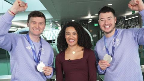 Bruce and Hammy with Nina, holding up their medals