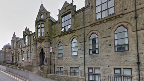 The Old Technical School a large gothic sandstone building with black framed windows