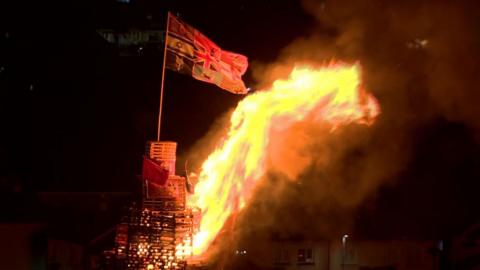 Bonfire with union and Israel flags alight