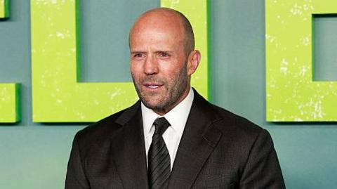 Jason Statham wearing a suit at the premiere of Shelter