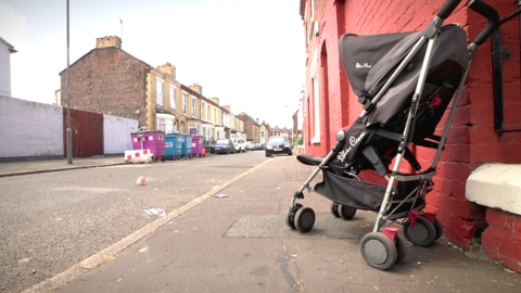 A Silver Cross pram on a terraced street in Liverpool