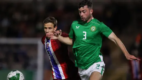 The Republic of Ireland's Sean Roughan battles for possession with Norway's Oliver Braude in Cork