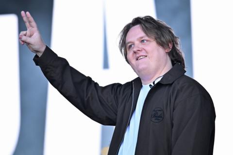 Lewis Capaldi gives the peace sign on stage at Glastonbury