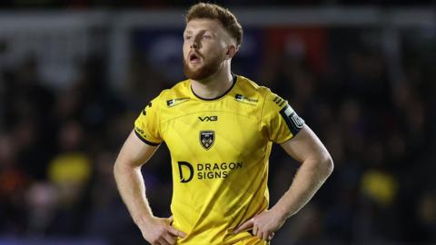 Dragons centre Aneurin Owen looks on from midfield with his hands on his hips