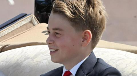 Prince George, head and shoulders, in a carriage at Trooping the Colour, June 2026
