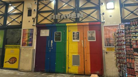 The Pride-themed doors of Heaven - the two doors are coloured purple, blue, green, yellow, orange and red. 