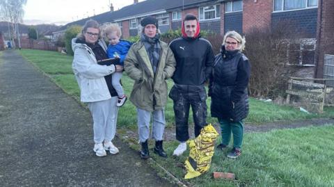 Residents next to the broken lamp-post