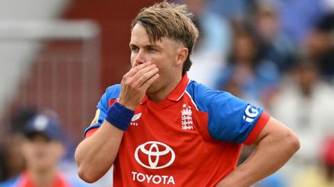 England bowler Sam Curran covers his mouth after delivering a ball