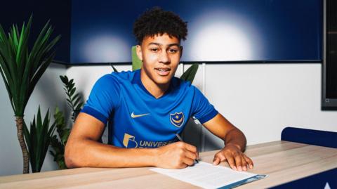 Luke Brooke-Smith poses for a photo after signing his Portsmouth contract 