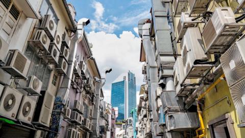 An alley in Singapore lined with dozens of air conditioning units