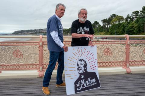 Michael Palin and Terry Gilliam pose with Terry Jones poster