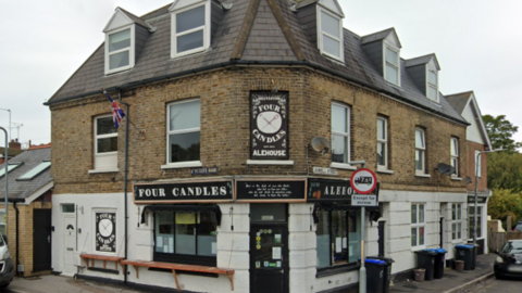 The Four Candles Alehouse micropub on 1 Sowell St, Broadstairs, Kent. One side of the sign says 'Four Candles' while the other says 'Alehouse'.