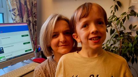 Wendy and Andrew Gallagher - Wendy has short bobbed blond hair and is wearing a light jumper and Andrew, her young son, has light brown hair and is wearing a long sleeve t-shirt