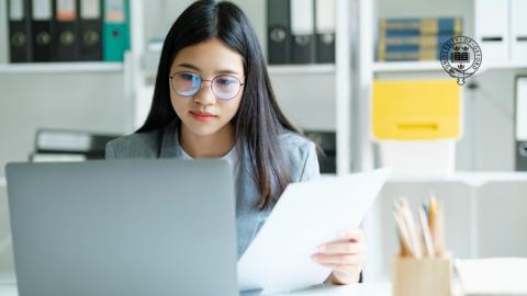 Woman works at a laptop