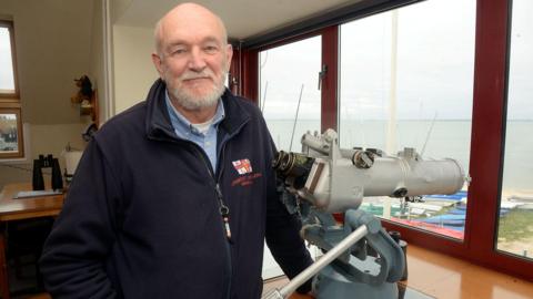 A coastguard volunteer inside a lifeboat station.