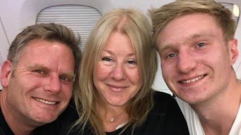 Chris Hall, his wife Fiona and their son Sam smile for the camera in a selfie