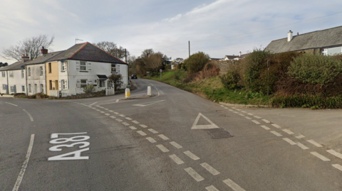 A387 road with houses in the background at Widegates