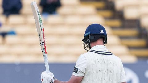 Beau Webster of Warwickshire celebrates scoring a half-century during the Rothesay County Championship match between Warwickshire County Cricket Club and Surrey at Edgbaston Cricket Ground in Birmingham, on April 5, 2026.
