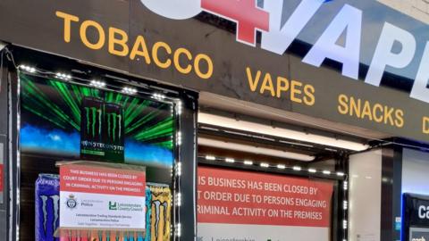 Signs stuck to the front of the Go4vape store in Loughborough saying why it's closed - "engaging in criminal activity on the premises"