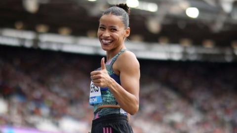 Jazmin Sawyers holds her thumbs up during a competition