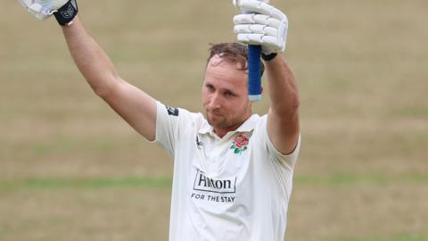 Tom Hartley raises his bat to acknowledge his maiden first-class century