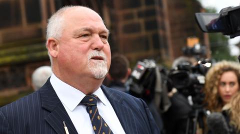 Mike Gatting, wearing a shirt and tie