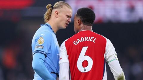 Erling Haaland squaring up to Gabriel 