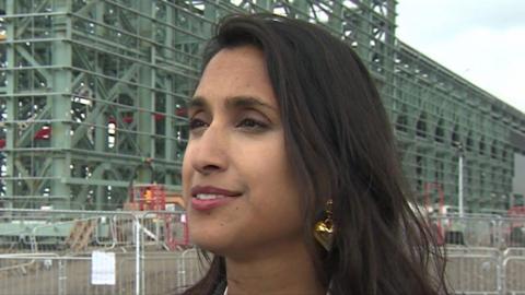 Energy Secretary Claire Coutinho with a building site in the background