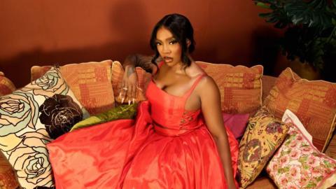 Tiwa Savage in a red dress