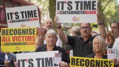 File photo dated 26/7/2023 of campaigners, including many who are personally infected and affected by infected blood, gather in Westminster, London, calling for compensation