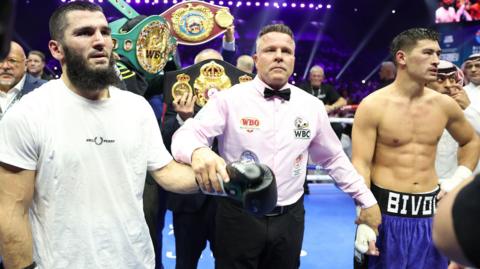 Artur Beterbiev and Dmitry Bivol wait for the scorecards